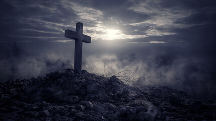 Solitary cross stands on a rocky mound in a misty landscape under a subdued sky, creating a somber and reflective atmosphere.