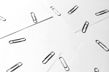 Paper Clips. Monochrome Stationery Template of Paperclips Arranged on White Office Desk.