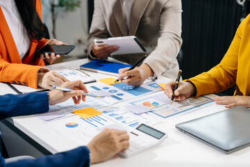 Businessman and team analyzing financial statement Finance task. with smart phone and laptop and  tablet.