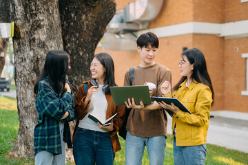 Young Asian People college students and a female student group work at the campus park