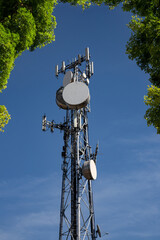 Metal tower with 5G antennas, parabolas