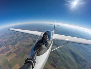 A glider pilot takes a selfie mid-flight, showcasing aerial views and adventure spirit.