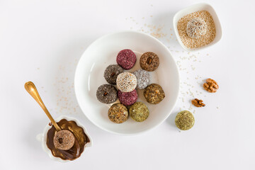 Healthy handmade sweets, balls, candies made from natural ingredients. Energy dessert made from nuts, cacao, seeds, coconut, berry. Vegetarian organic food. White background