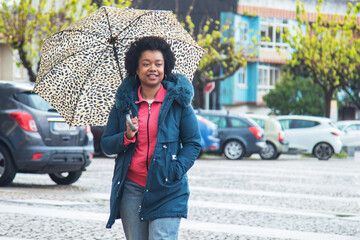 happy free afro woman posing on the street