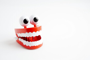 Funny red teeth with eye toy denture model for dental health care.