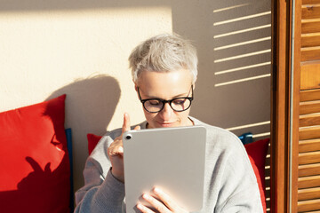 50S Older Mature Middle Aged Stylish European Woman Looking At  Digital Tablet. Video Conference,...