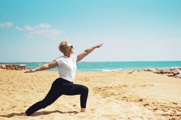 Middle Aged Female Doing Warrior Pose Yoga Exercises. Mindfulness Zen Spiritual Meditation Tips....