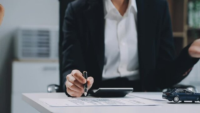 Car salesman gave the keys to the customers who signed the purchase contract legally, Successful completion of car sales, Purchase contract and key delivery.