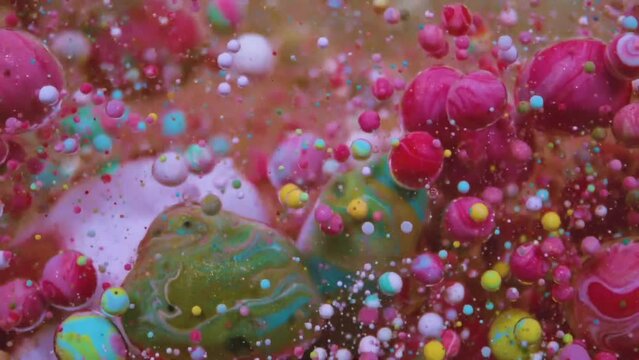Oil paint colors merge, they form a fluid amalgamation, resulting in an abstract and artistic composition that embodies the essence of creative experimentation and expression. Color bubbles.