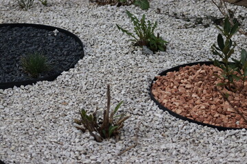 Decorative stone bed. Garden edging and colored stones