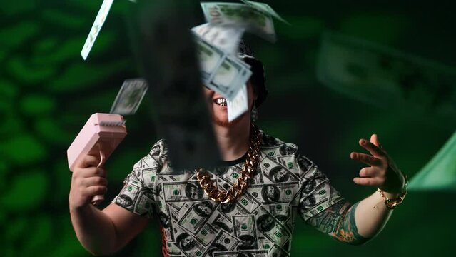 Art shot with crazy guy shooting from pistol by money, medium portrait in studio, rich and success