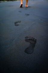 soles of feet, footprints on the beach sand