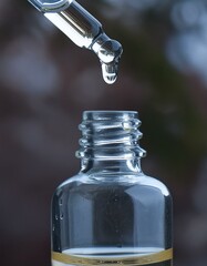 oil dripping from dropper dark background.