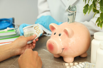 A doctor with a piggy bank on the table, the concept of corruption in medicine.