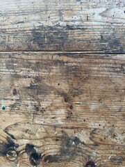 Close-up shot of an old wood surface with intricate details, scratches, knots and colors