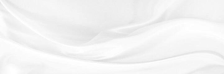 White gray satin texture that is white silver fabric silk panorama background with beautiful soft blur pattern natural.