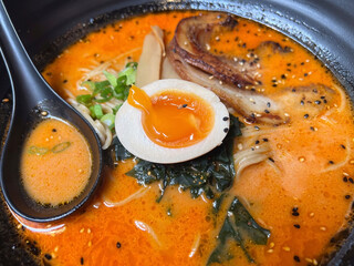 Japanese ramen noodle soup with egg in black pot