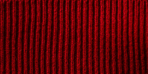 Texture of red knitted fabric as a background