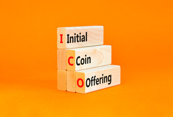 ICO initial coin offering symbol. Concept words ICO initial coin offering on beautiful wooden blocks. Beautiful orange background. Business ICO initial coin offering concept. Copy space.