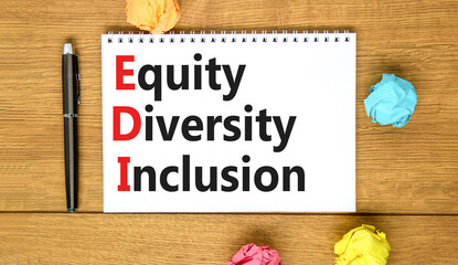 EDI equity diversity inclusion symbol. Concept words EDI equity diversity inclusion on white note. Beautiful wooden table wooden background. Business EDI equity diversity inclusion concept. Copy space