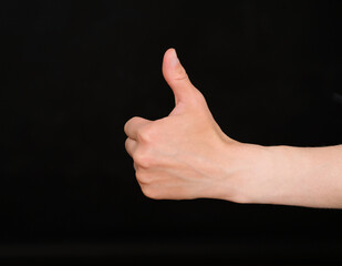 Human hand shows a thumb up gesture