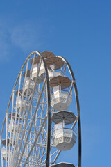 Detail of a white ferris wheel against blue sky