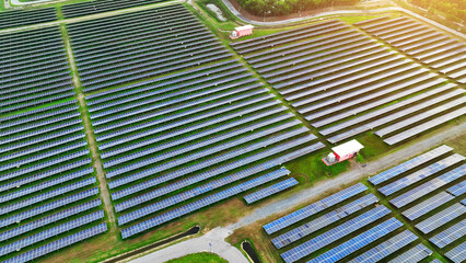 Obraz premium A mesmerizing drone perspective reveals a high-tech solar farm, sleek and efficient, powering the future with sustainable energy. Clean power from nature's gifts: Renewable energy. 