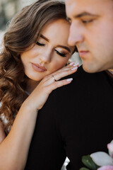 Fototapeta premium A man and a woman are hugging each other. The woman is wearing a ring on her finger
