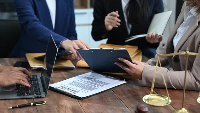 business people and lawyers discussing contract papers sitting at the table. Concepts of law, advice, legal services.