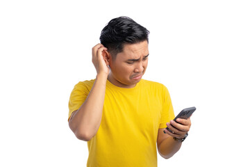 Handsome young Asian man holding mobile phone and scratching his head, confused about something isolated on white background