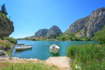 Scenic view of Omis where the Cetina river meets the Adriatic sea, Dalmatia, Croatia. Cozy town with beach and greenery surrounded by Dinara mountains, outdoor travel background, tourist resort