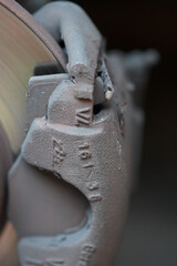 incorrectly installed car brake pads on calipers, highlighting potential safety hazards and the importance of proper installation.