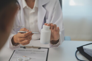 Healthcare service and pharmacy worker with customer at store counter for medication explanation. Pharmaceutical advice and opinion of pharmacist helping girl with medicine information.