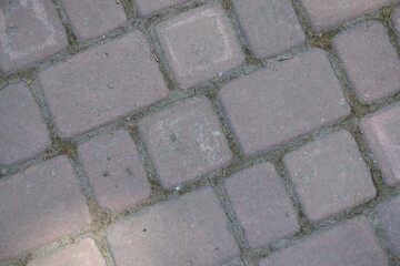 Close view of old and dusty pale pink concrete pavement