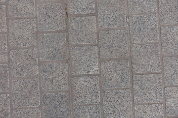 Obraz premium Close up of pavement made of gray unpolished granite stone blacks