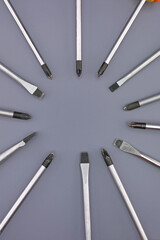 Metal screwdrivers with various tips for electrical work. Close-up.