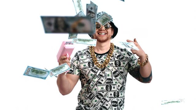 Portrait of crazy rich man throwing money by toy pistol in white background, slow motion, art shot