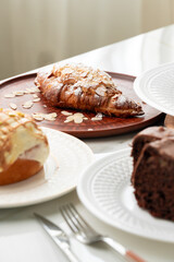 Homemade desserts sponge cake and cinnamon bun on table