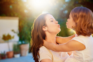Mother, daughter and kiss or hug, outdoor and cheerful with happiness, care and holiday....