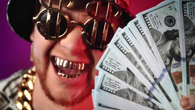 Closeup portrait of broad smile with gold teeth of crazy rich man, male person swaying dollars
