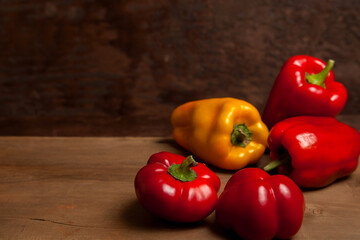 Assort of different shape and color bell pepper on wooden background..