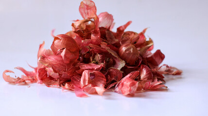 pile of red onion skins isolated on white, food waste used as natural fertilizer, kitchen waste management concept