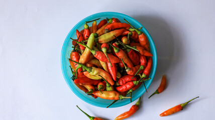 red cayenne pepper in a green bowl. spicy flavored vegetables