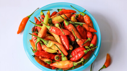 red cayenne pepper in a green bowl. spicy flavored vegetables