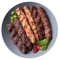 Set of kebabs with lamb, veal, and chicken. Two pieces of each on a gray plate. On a white background.