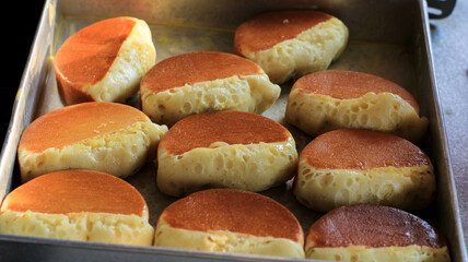 pukis cake making. Pukis is made of a wheat flour-based batter and cooked in a special mold pan