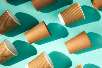 A paper cups on a blue background. Eco friendly pattern, zero waste concept. Top view