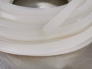 U-shaped silicone seal, white, for sealing against dust and liquids. Long lines, used in industrial plants, illustrations