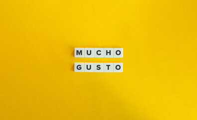 Nice to meet you (Mucho Gusto) Phrase in Spanish Language. Text on Block Letter Tiles on Yellow Background. Minimal Aesthetics.