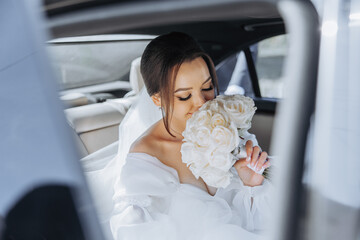 A bride is getting into a car with a bouquet of white roses. The scene is intimate and romantic,...